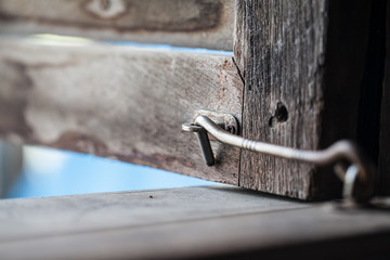 Old window hook with wooden window