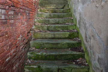 Concrete stairs between the brickwork and mortar wall
