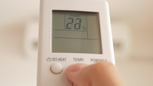 Air conditioning room temperature changing with remote control 4K 3840X2160 UHD footage - Temperature change with remote controlled air conditioner 4K 2160p UHD video 