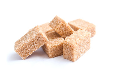 sucre de canne en morceaux sur fond blanc
