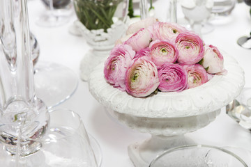 decoration of wedding table. pink ranunculus (persian buttercup)
