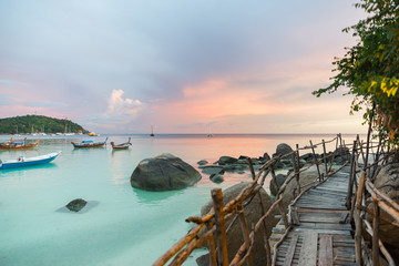 Wood bridge with sunset at pattaya beach in Koh Lipe Island - obrazy, fototapety, plakaty