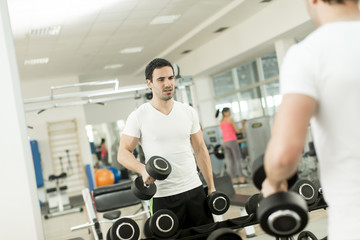 Fototapeta na wymiar Young man training in the gym