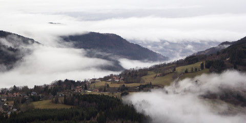 Fototapeta na wymiar Alpine village in the fog. France, rhone-Alpes