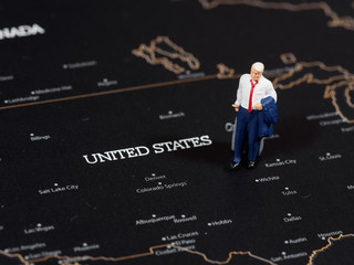 Miniature business man on map of United States