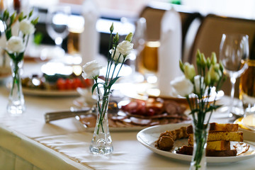 Elegant stylish decorated wedding reception tables with glasses