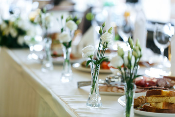 Elegant stylish decorated wedding reception tables with glasses