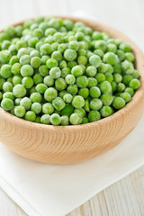 frozem peas on wooden surface