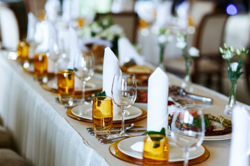 Elegant stylish decorated wedding reception tables with glasses