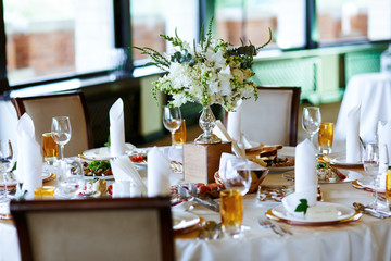 Elegant stylish decorated wedding reception tables with glasses