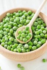 frozem peas on wooden surface