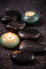 spa concept with stone and candles  on wooden table ,