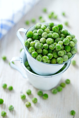 frozem peas on wooden surface