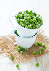 frozem peas on wooden surface