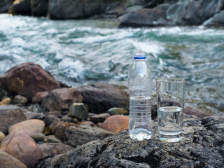 Natural mineral water in a glass from a bottle