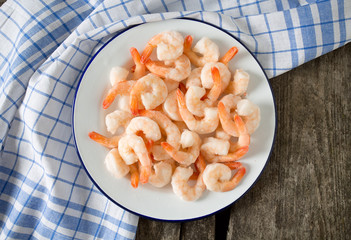 frozen shrimps on wooden surface