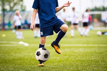 Foto auf Acrylglas Fußball Boy Playing Soccer Football Match on a Sports Stadium
