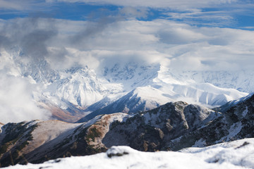 Fototapeta premium Close view of snowy mountain ridge shrouded in clouds. Georgia (Svaneti)