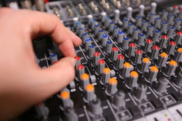 TV editor working with video and audio mixer