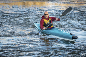 senior male paddler kayaking