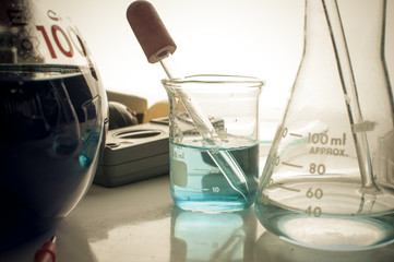 science laboratory test tubes with periodic table background