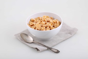 Corn and rice flakes in a white cup, a breakfast