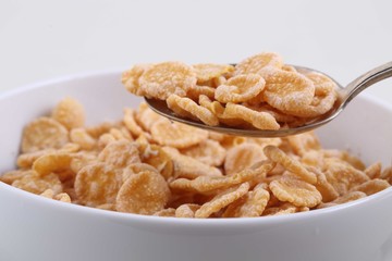 Corn and rice flakes in a white cup, a breakfast