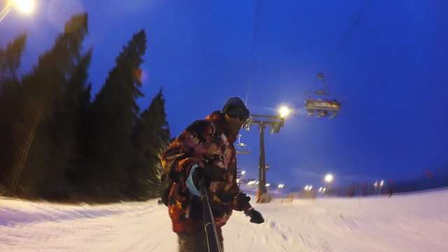 Man riding on snowboard in the evening