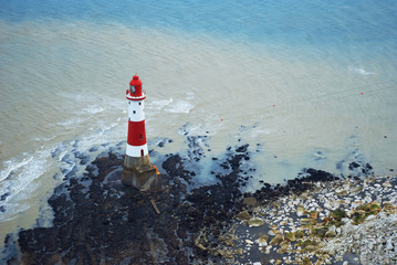 Lighthouse at the foot of the Beachy Head cliff, UK. - 103276919