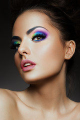 Close-up portrait of beautiful woman with bright make-up and hairstyle.