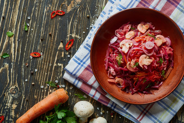 Bowl with salad on wooden board