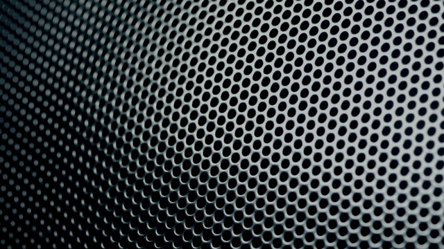 Metallic grid motion background. Dark metal background with perforated holes. 