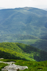 stones in valley on top of mountain range at sunrise