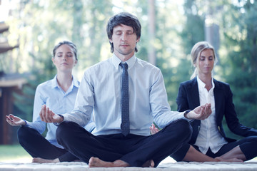 Business people practicing yoga
