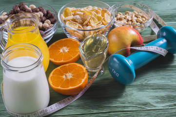 The concept of a healthy lifestyle. Cornflakes, orange juice, yogurt, nuts, honey, tangerines,...