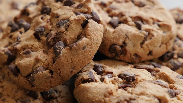 Lot of chip cake cookies with chocolate close-up tilting 4K 3840X2160 30fps UHD footage - Slow tilting on biscuit cookies arranged on table 4K 2160p UltraHD video 