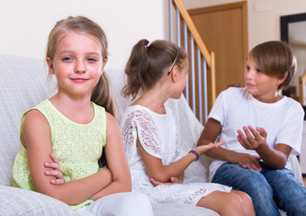 child sitting aside of boy and girl