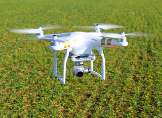 Drone quadrocopter with camera. New tool for farmers use drones to inspect of cultivated fields. Modern technology in agriculture.
