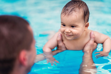 Smiling baby boy in swimming pool