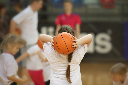 Rear view of girl with basketball ball