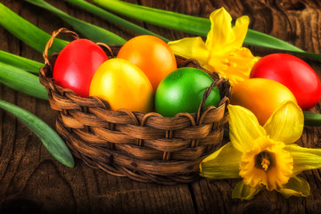 Colorful Easter decoration on dark wood with sunlight effect