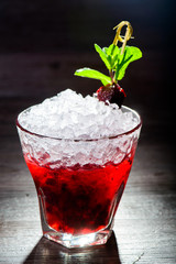 alcoholic cocktail with black currants
