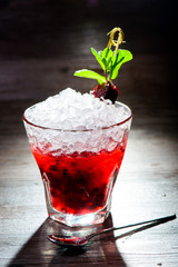 alcoholic cocktail with black currants