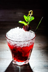 alcoholic cocktail with black currants
