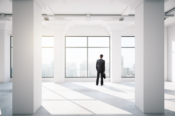 businessman standing in empty office