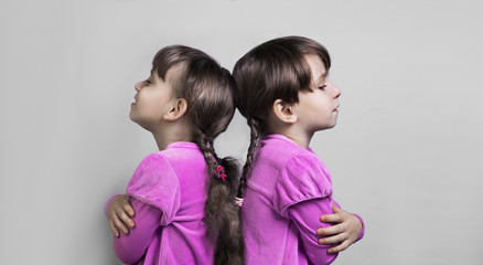 Two beautiful little girls sister twins - obrazy, fototapety, plakaty