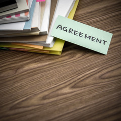 Agreement; The Pile of Business Documents on the Desk