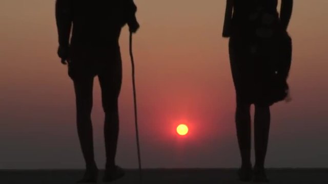 Bushmen walking into the sunset on the Makgadikgadi Pans 