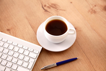 Office table with blank notepad and laptop 