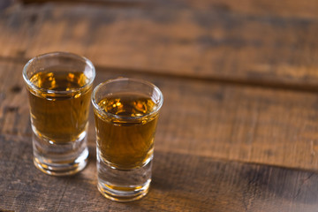 whiskey in glass on wood background